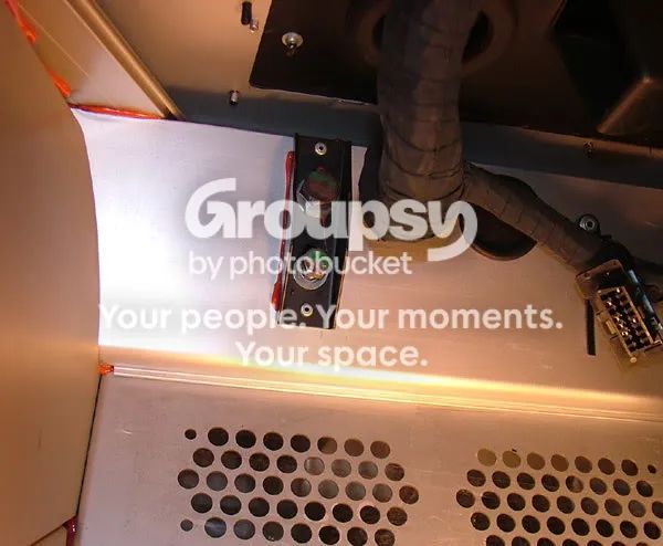 The black steel bracket and bolts holding the rack to the floor, seen from inside the footwell