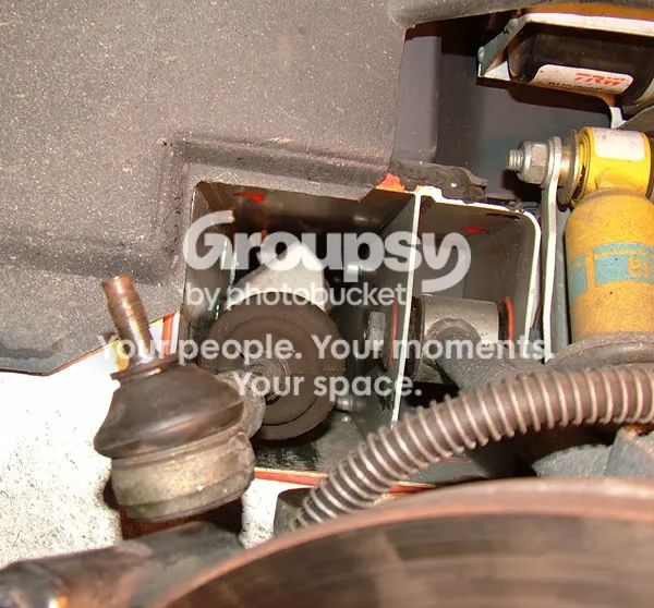 The rack tunnel in the right-hand wheel arch with a track-rod end and ball joint at the left