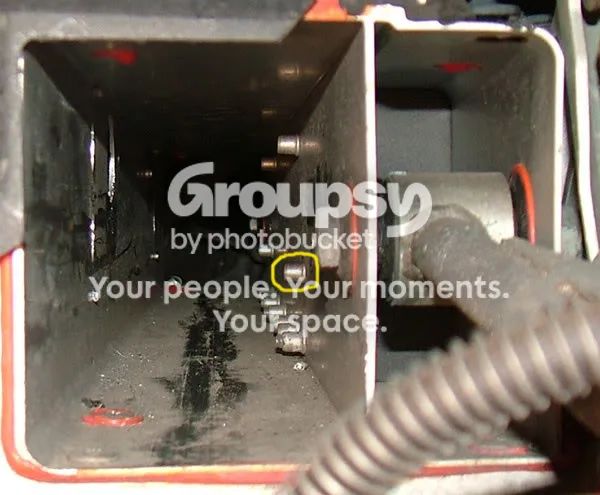 Looking up into the rack tunnel with a Rivnut circled in yellow