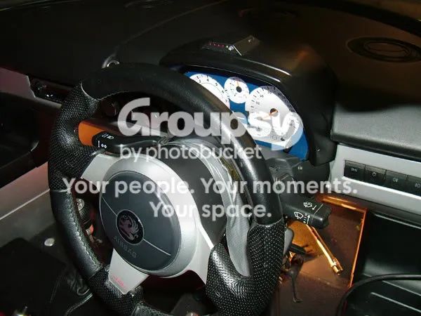 The steering wheel centred in a dark cabin