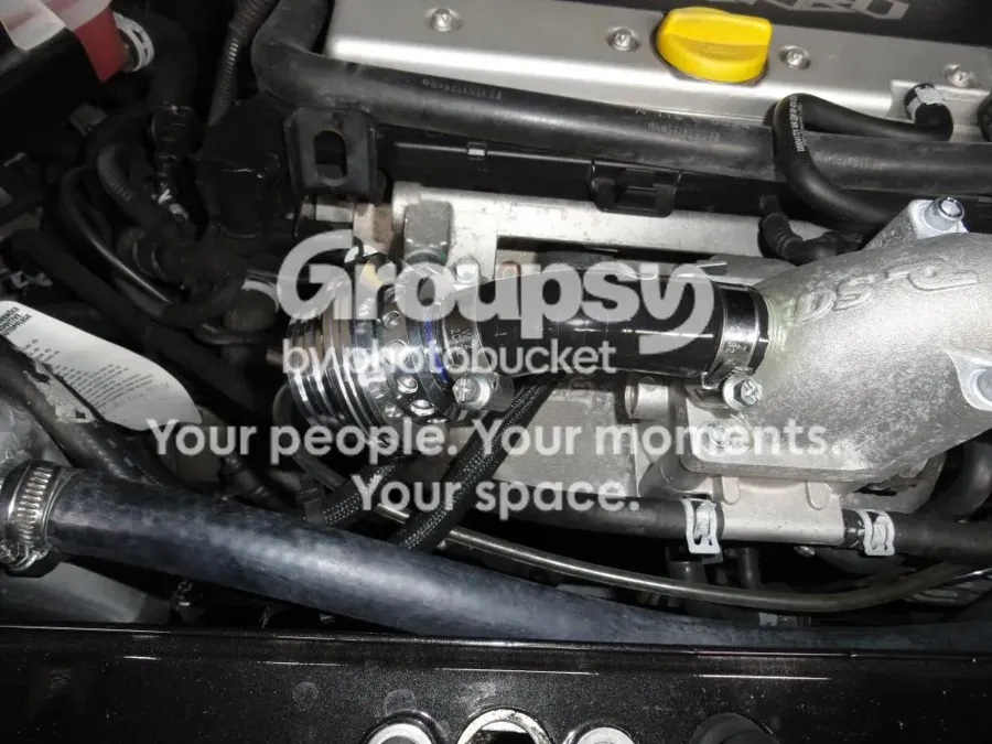 A Forge valve with a polished body fitted on a hose beside the inlet manifold of a Turbo engine