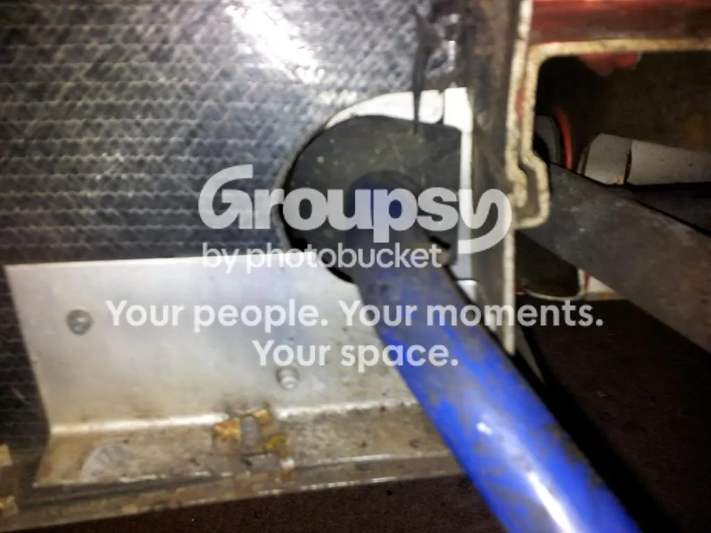 The blue anti-roll bar passing in front of the lower wishbone mounting