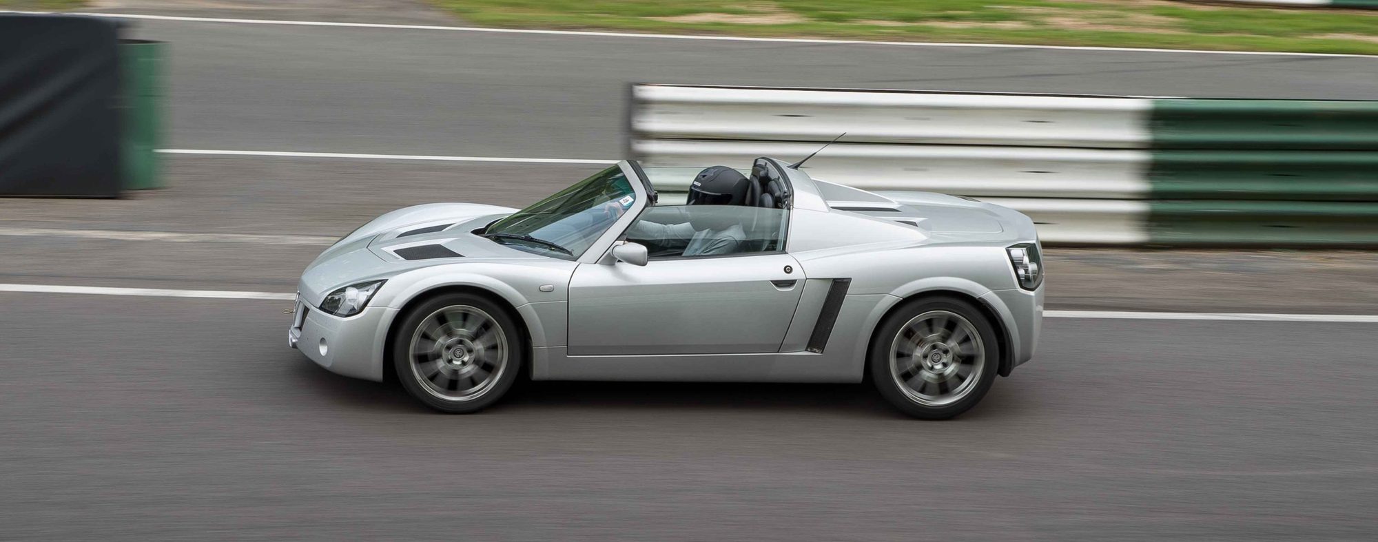 A silver Vauxhall VX220 on track